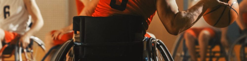 Wheelchair Basketball Game Court: Active Professional Player Dribbling Ball, Prepairing to Shoot and Score a Goal. Determination, Inspiration, and Skill of a People with Disability.